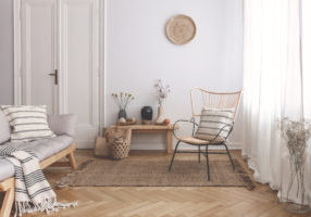 Armchair,On,Rug,Next,To,Bench,With,Plants,In,White